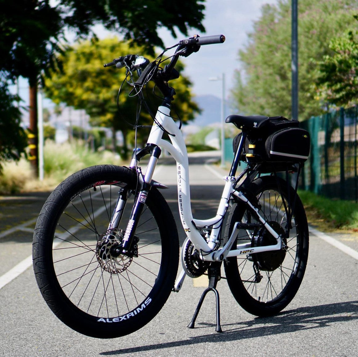 white electric bike on a paved trail